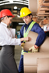 Image showing Supervisor And Foreman Checking Cardboard At Warehouse