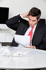 Image showing Confused Businessman Working At Desk