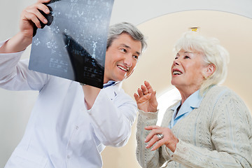 Image showing Doctor With Patient Looking At X-ray