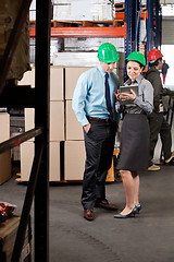 Image showing Supervisors Using Digital Tablet At Warehouse