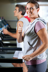 Image showing Woman And Man Running On Treadmill