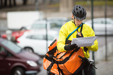 Image showing Male Cyclist With Package And Courier Bag On Street