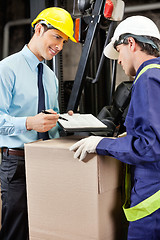 Image showing Male Supervisor Showing Clipboard To Foreman