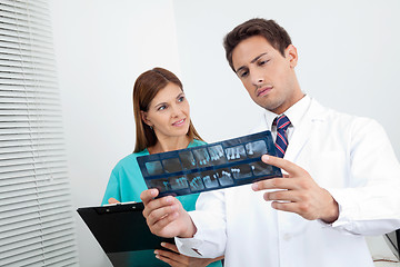 Image showing Doctor And Assistant Analyzing Patient's Report