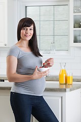 Image showing Pregnant Woman Eating Healthy Bowl Of Fruit