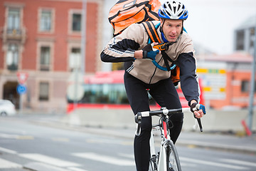 Image showing Male Cyclist With Courier Delivery Bag Riding Bicycle