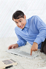 Image showing Geek Businessman Pressing Buttons Of Keyboard