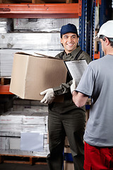 Image showing Foreman Looking At Supervisor With Clipboard