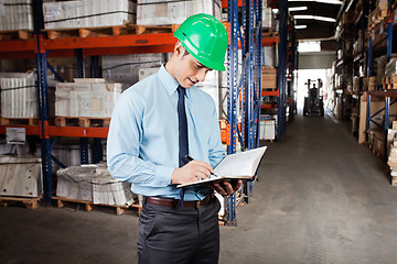 Image showing Supervisor Writing Notes At Warehouse