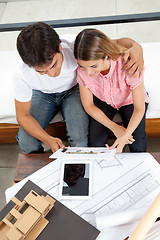 Image showing Couple Looking At House Plans