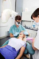 Image showing Dentist And Female Assistant Treating A Patient At Clinic