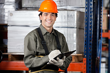 Image showing Young Male Supervisor With Clipboard Smiling