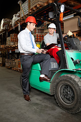 Image showing Supervisor Showing Clipboard To Forklift Driver