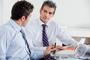 Image showing Businessmen Discussing Paperwork In Office