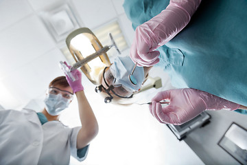 Image showing Female Dentist And Assistant Conducting Dental Operation