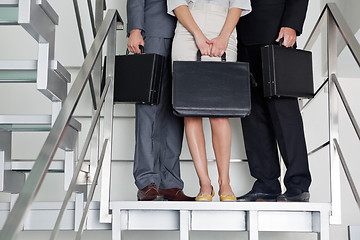 Image showing Businesspeople With Briefcases Standing On Steps