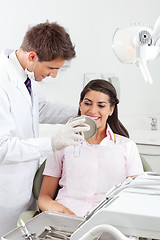 Image showing Dentist Showing Result Of His Work To Patient