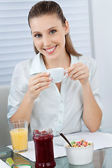 Image showing Beautiful Young Woman Having Tea