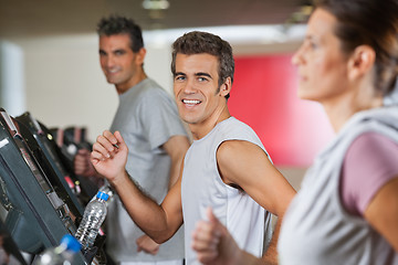 Image showing Men And Woman Running On Treadmill