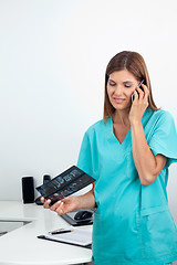 Image showing Dentist With X-Ray Report Using Cellphone