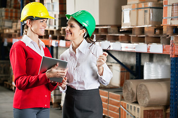 Image showing Female Supervisors Discussing Work At Warehouse