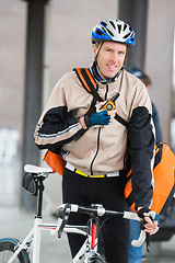 Image showing Male Cyclist With Courier Bag Using Walkie-Talkie