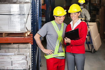 Image showing Happy Supervisor Showing Clipboard To Foreman