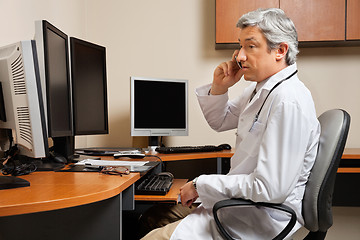 Image showing Doctor Attending Phone Call At Clinic