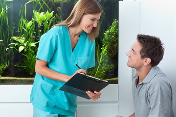 Image showing Dentist Taking An Appointment Of Man