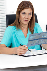 Image showing Dentist Analyzing Dental X-Ray Report