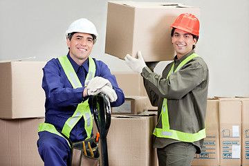 Image showing Foremen Loading Cardboard Boxes At Warehouse