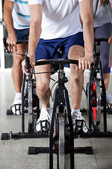 Image showing Low Section Of People On Exercise Bikes