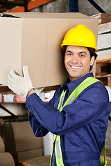 Image showing Young Foreman Lifting Cardboard Box