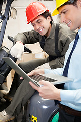 Image showing Supervisor And Forklift Driver Using Laptop