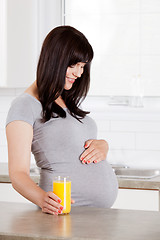 Image showing Pregnant Woman Looking Down at Belly