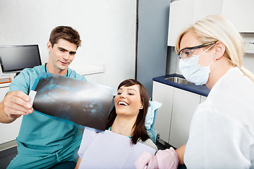 Image showing Dentist With Female Assistant Showing X-Ray Image To Patient