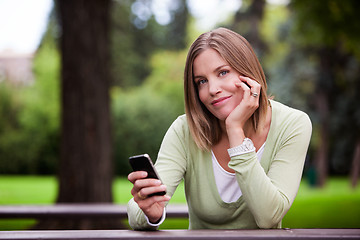 Image showing Woman holding Cell Phone