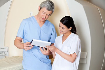 Image showing Technicians Looking At Clipboard