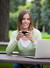 Image showing Woman holding Cell Phone