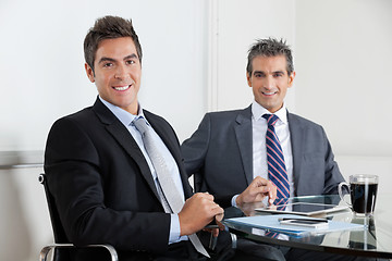 Image showing Businessmen Using Digital Tablet In Office