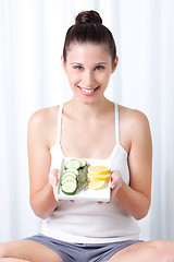 Image showing Young Woman holding salad
