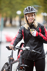 Image showing Female Cyclist With Courier Bag Using Walkie-Talkie