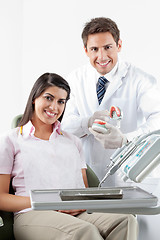 Image showing Dentist And Patient With Teeth Model In Clinic