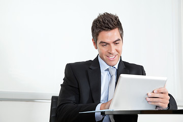 Image showing Young Businessman Using Digital Tablet In Office