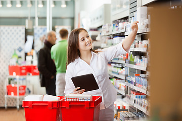 Image showing Smiling Woman Using Digital Tablet For Shopping At Supermarket