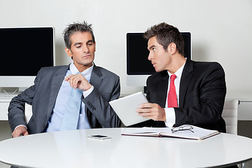 Image showing Businessmen Using Digital Tablet At Desk