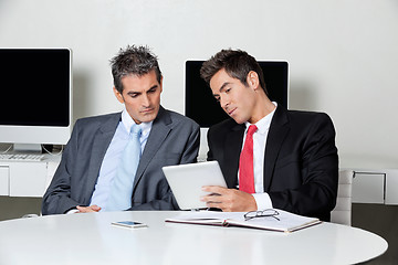 Image showing Businessmen Using Digital Tablet At Desk