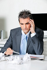 Image showing Tensed Businessman Sitting At Desk