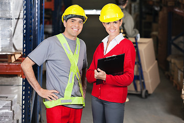 Image showing Supervisor Holding Clipboard Standing With Foreman At Warehouse