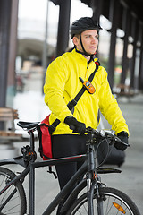 Image showing Young Man With Bicycle And Bag Looking Away
